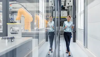 Professional woman walking in manufacturing