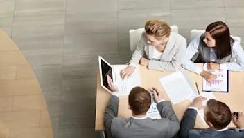 Four individuals having a business meeting.