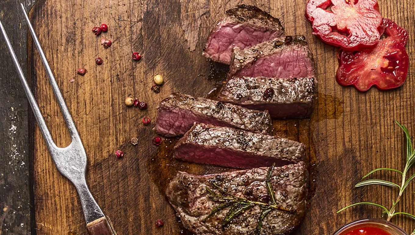 Sliced steak on a chopping board