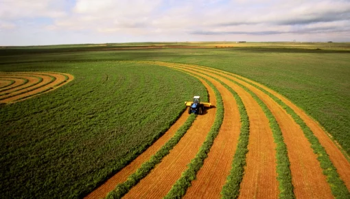 A tractor drives through a field.