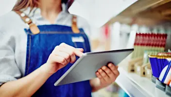 An employee uses software on a tablet