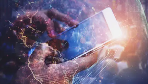 Smartphone in hands behind digital world map