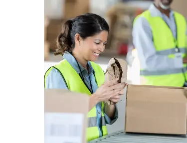 Woman smiling working in a warehouse.