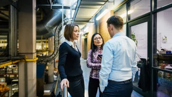 Factory Management Discussing in Hallway