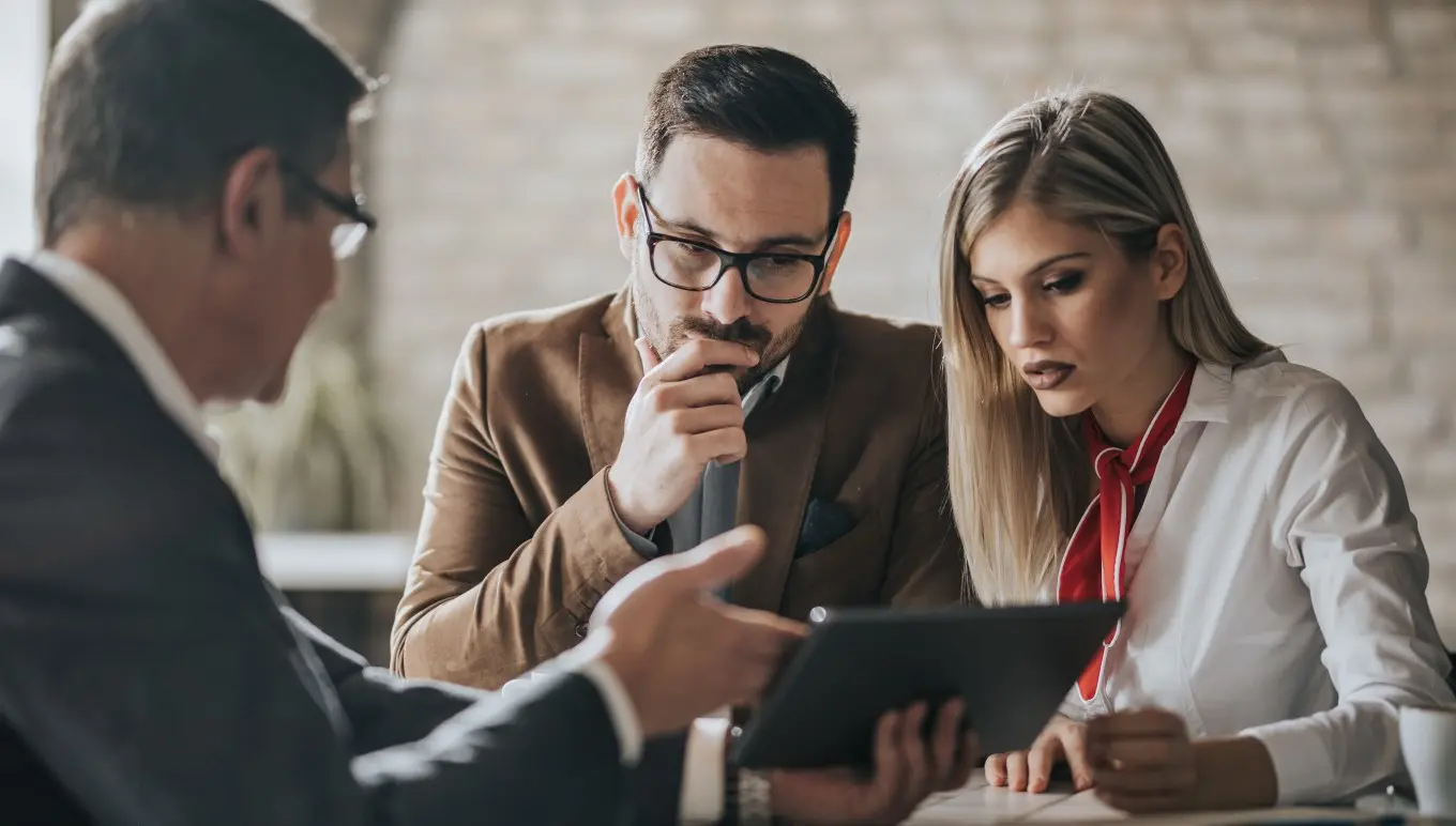 Couple looking at a table from a financial advisor.