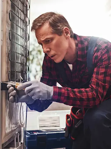 Repair man working on appliance