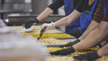 Snack producer line workers preparing product