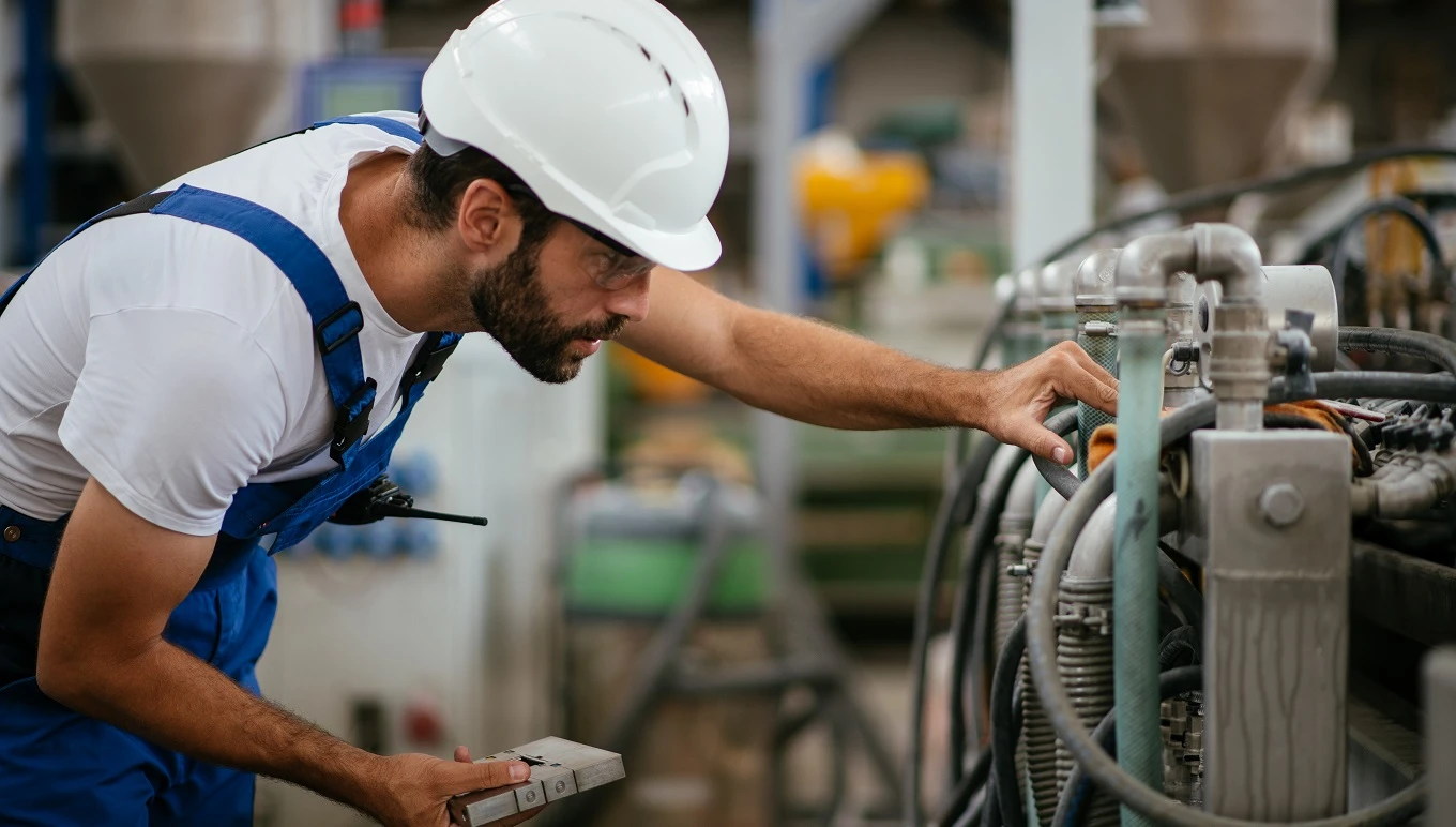 Maintenance worker adjusting machine