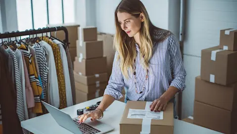 Preparing to shipping package with laptop on desk