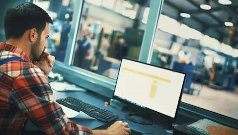 Man on computer in control room