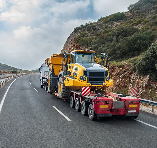 A truck that transports a large tipper lorry
