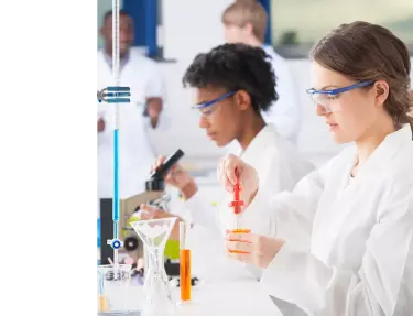People in a laboratory handling chemicals. 