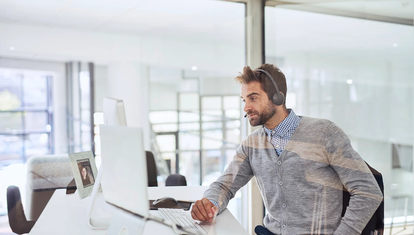 Man sitting in office in front of computer.
