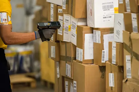 Worker scanning barcodes on boxes