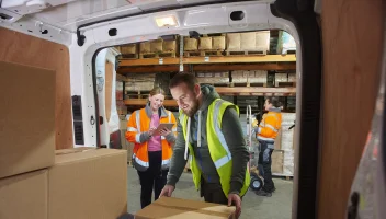 Man stacking boxes into a van