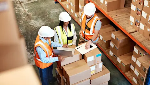 Workers standing in the warehouse and talking.