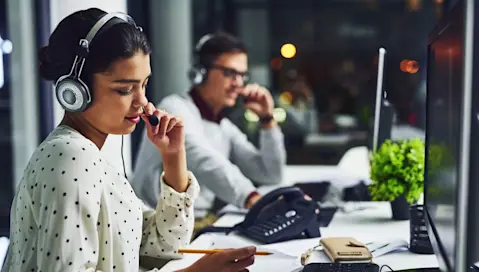 Customer service representative sitting at a desk