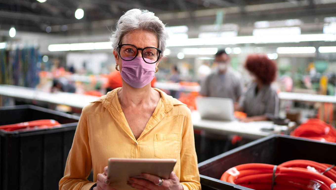 Woman in mask with tablet