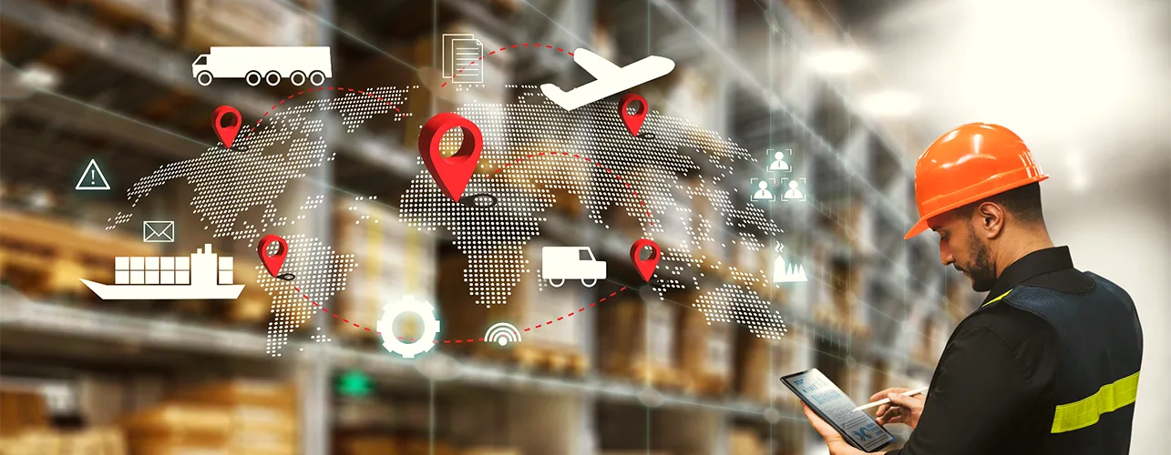 Man looking a tablet in warehouse featuring digital graphics of the supply chain 