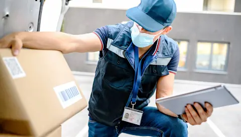 Delivery driver inspecting box