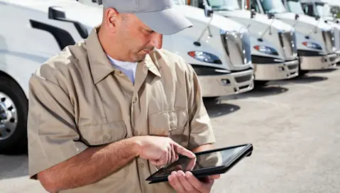 Fleet operator reviewing tablet scheduling