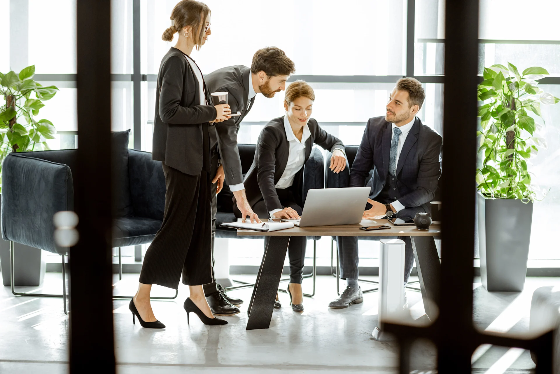 White-collar bank employees during a small conference or meeting with laptop at the luxurious office