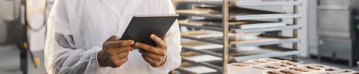 Man on tablet in bakery