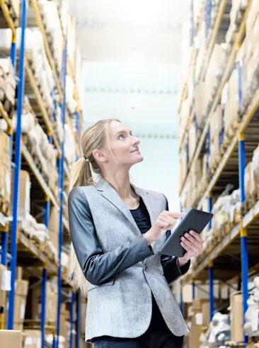 Woman on tablet counting inventory.