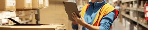 Worker using handheld touchscreen tablet