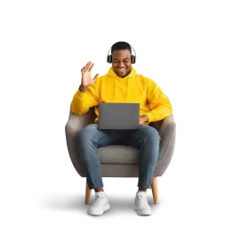 Person sitting in a chair while taking a video call on a laptop