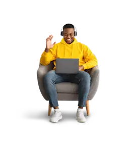 Person sitting in a chair while taking a video call on a laptop