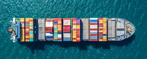 Aerial photo of a container ship out on the ocean.