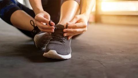 Person tying their shoe