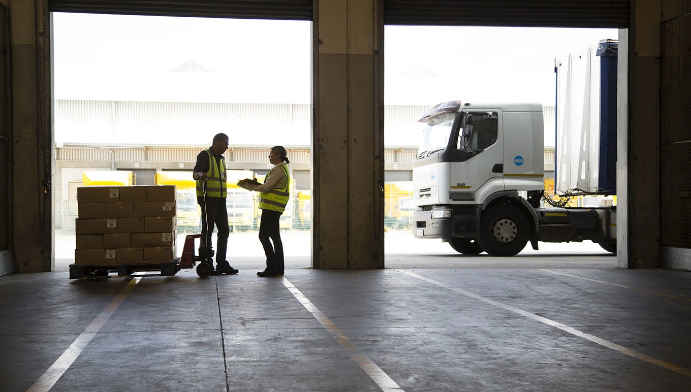 two people standing in a garage