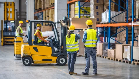 Forklift operators in warehouse