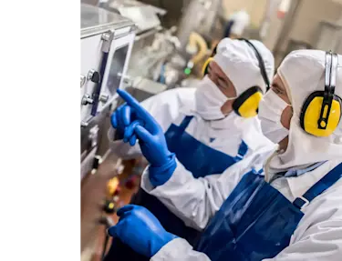 Two men looking at a machine in a factory.