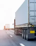 A line of trucks driving on a highway