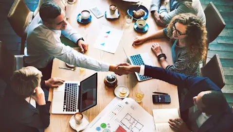 Food and beverage business leaders meet and shake hands.