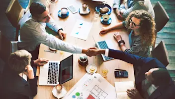 Food and beverage business leaders meet and shake hands.