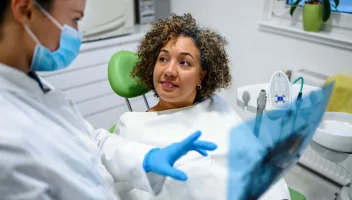 Dentist showing x-ray results to patient