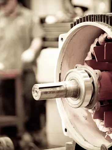 Shop repair worker fixing motor