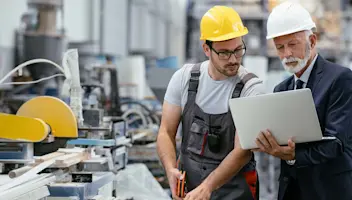 Manufacturing workers with laptop