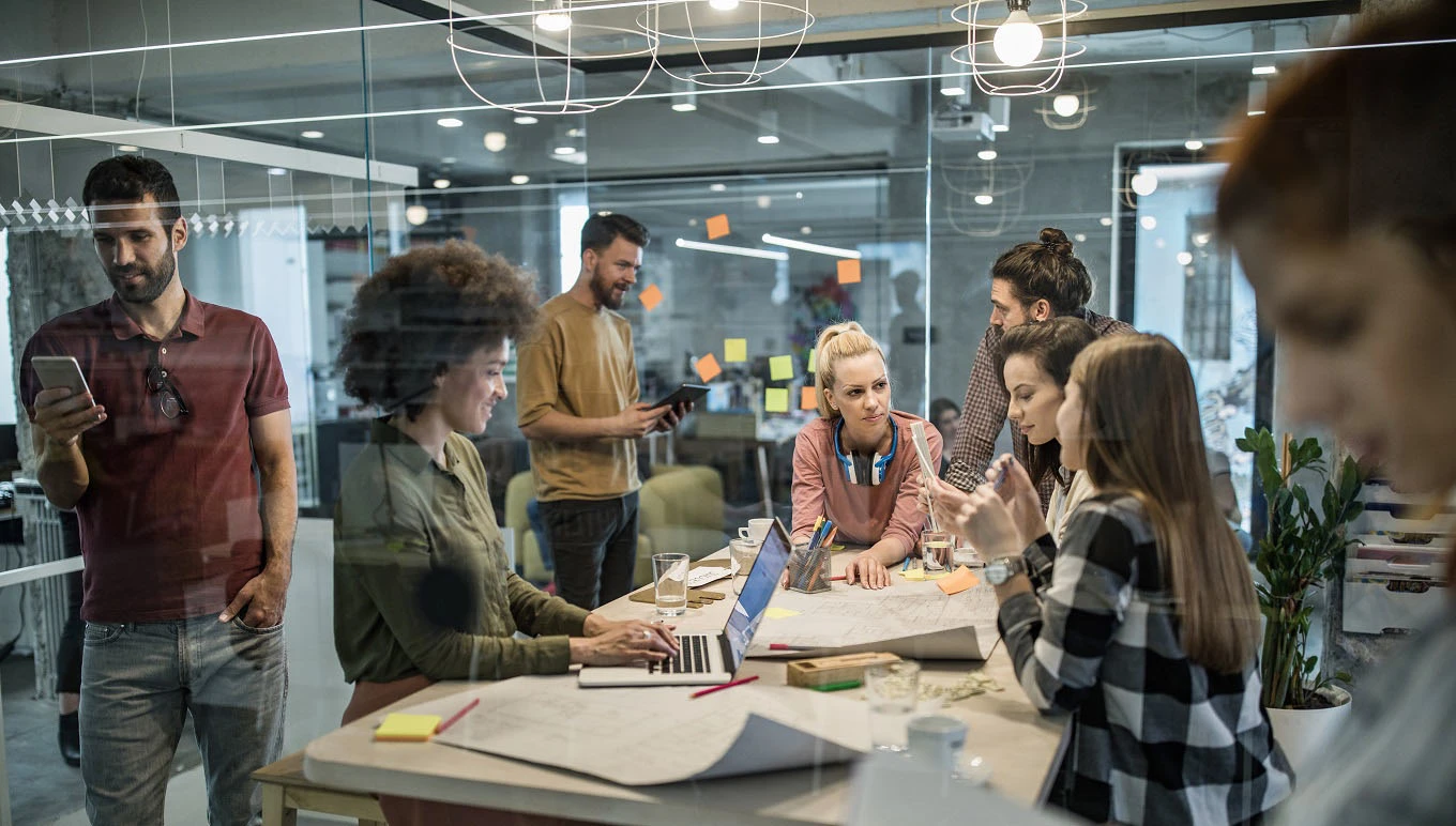 Office workers meeting around table without social distancing