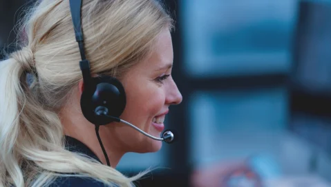 Smiling woman on headset for customer service