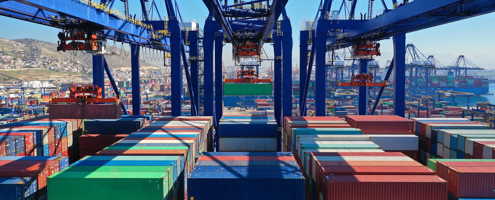 Aerial view of colourful shipping containers at a seaside logistics port