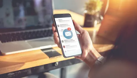 A person checking their email on a cell phone.