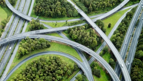 Trucks drive on highway interchanges.