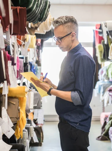 Man taking inventory of textiles