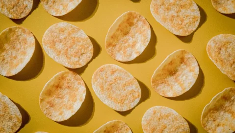 Potato chips on a yellow background.