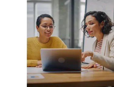 Two woman looking at laptop